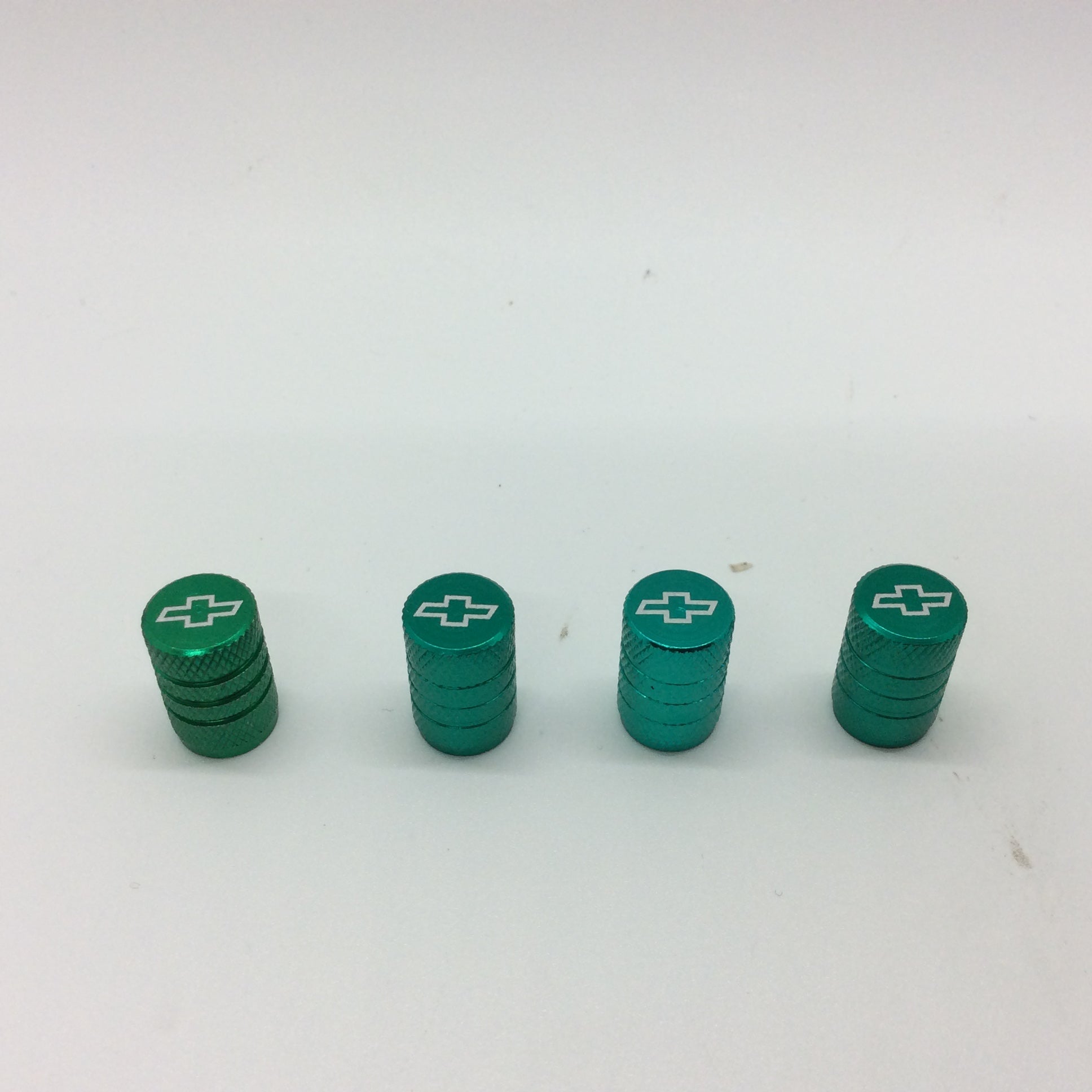 a set of four green tire stem caps sitting on top of a table