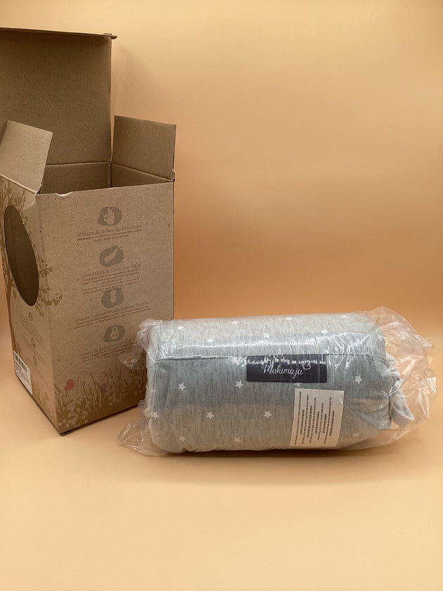 a package of toilet paper next to a cardboard box